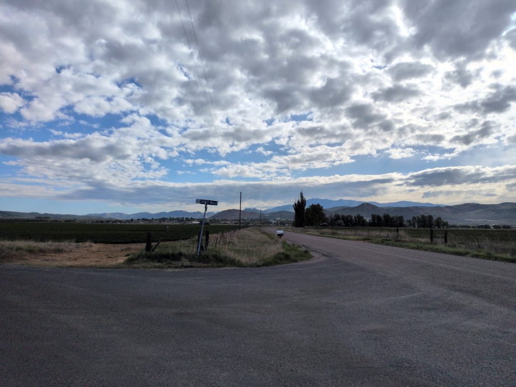 Dirt road heading north toward Aid Station 4 with mountains in the distance.