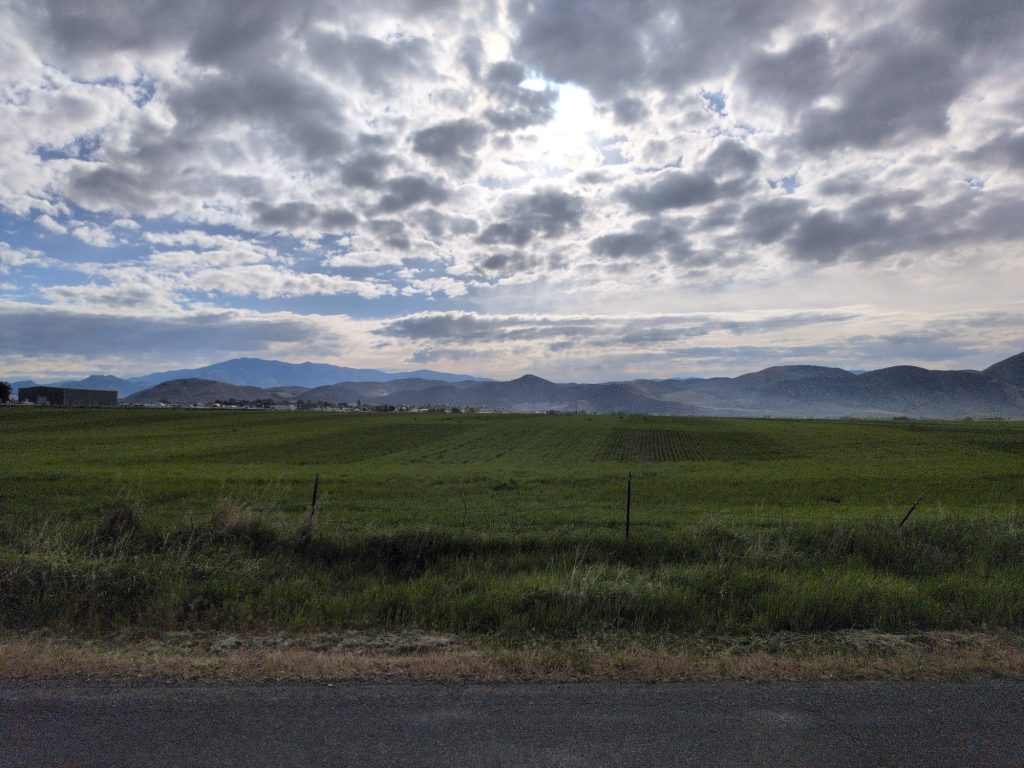 Mile 10 of the Malad Valley Marathon course with farm fields and the Sublett Range on the horizon.
