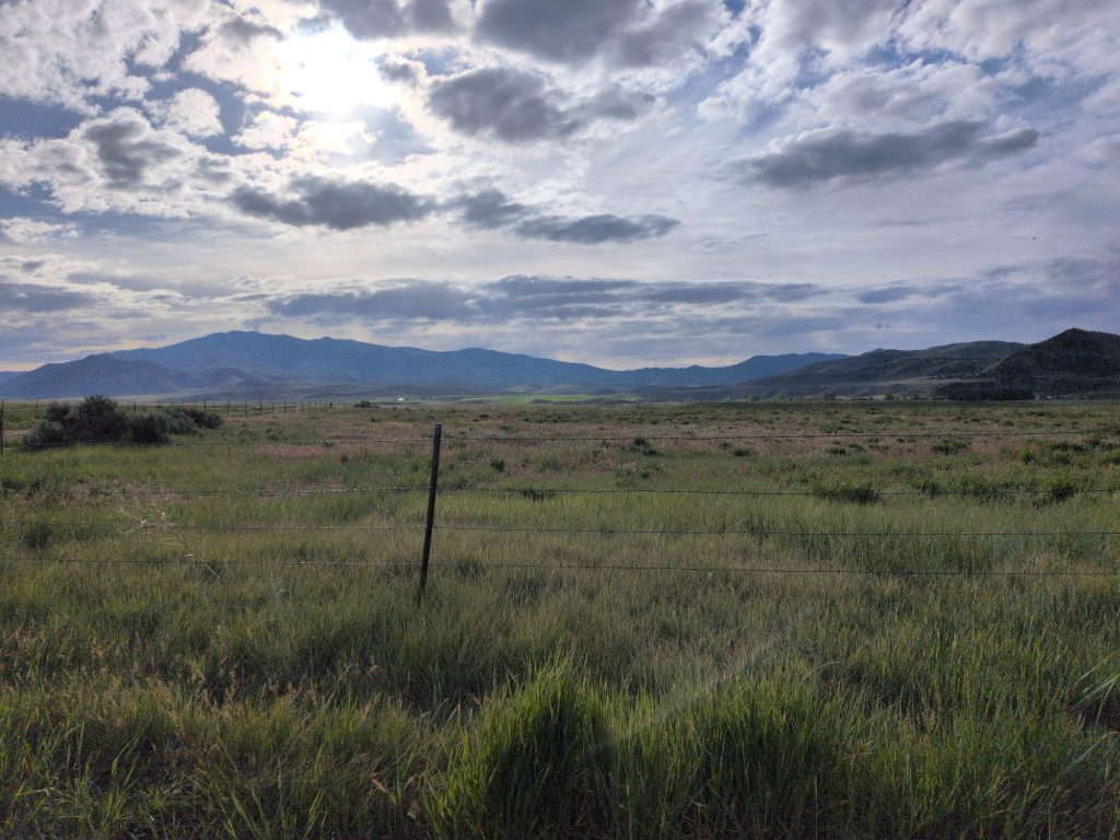 Reddish butte and pasture gate at the Red Rock turn on the Malad Valley Marathon course.